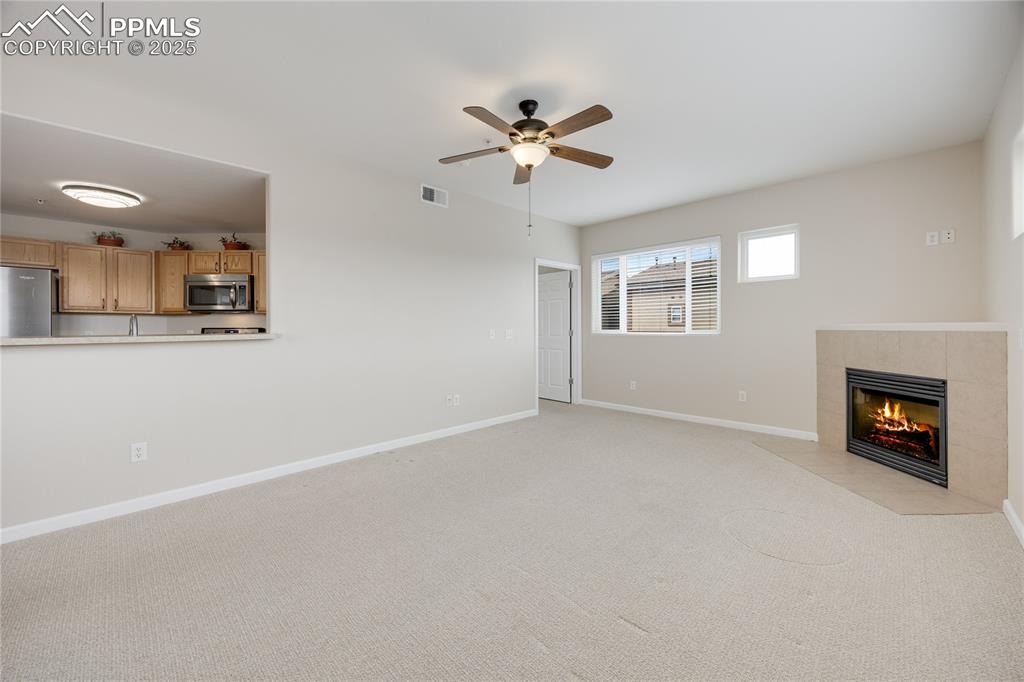 Image 14 of 42: Kitchen overlooks spacious living room