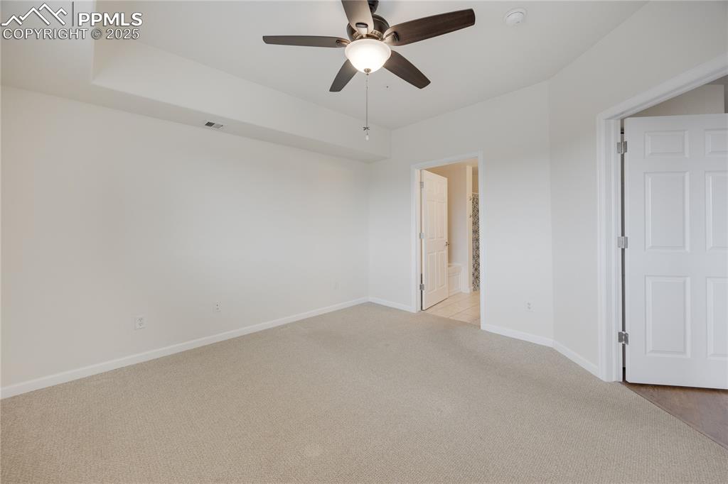 Image 19 of 42: Large primary bedroom. Unit has AC and ceiling fans in all the bedrooms.