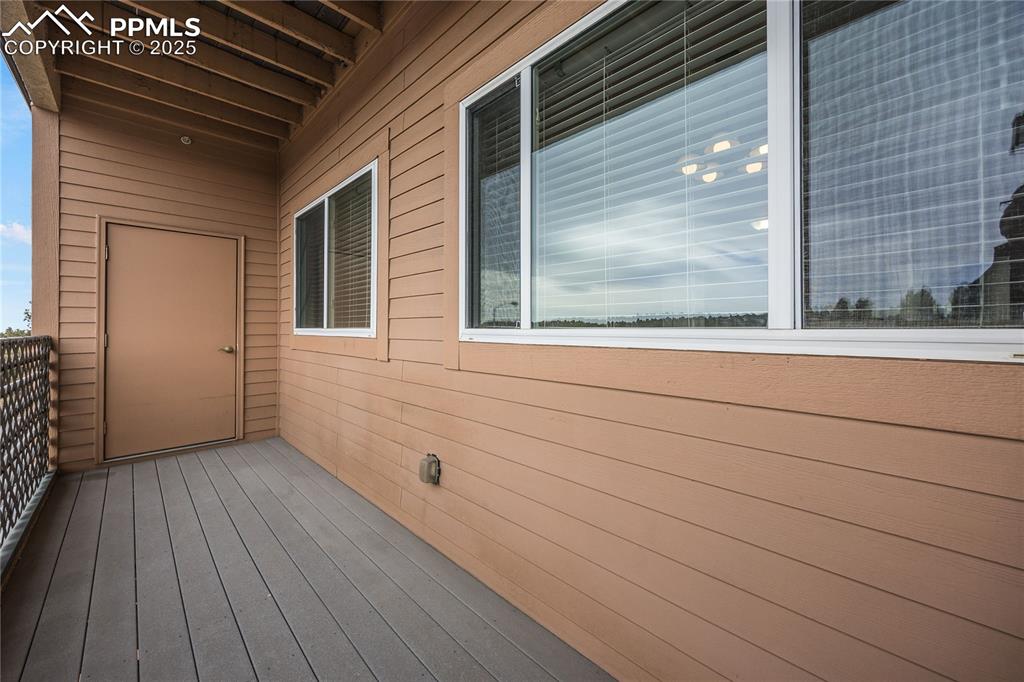 Image 35 of 42: Balcony off living room. HVAC closet is behind door at end of balcony