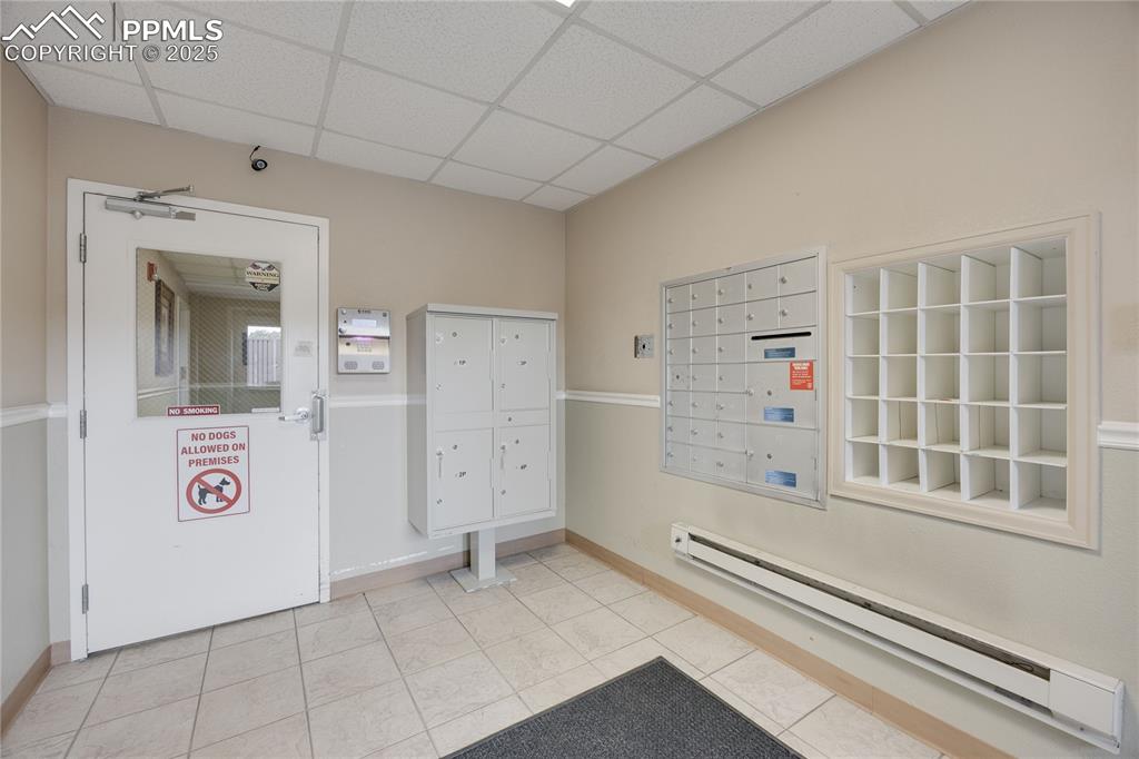 Image 36 of 42: Entrance lobby with mailboxes protected from elements. Access requires key,