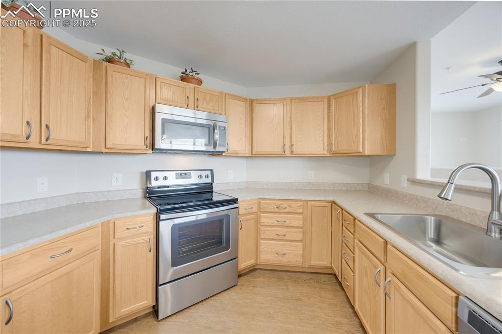 Image 6 of 42: Kitchen features stainless steel appliances with loads of storage in oak ca
