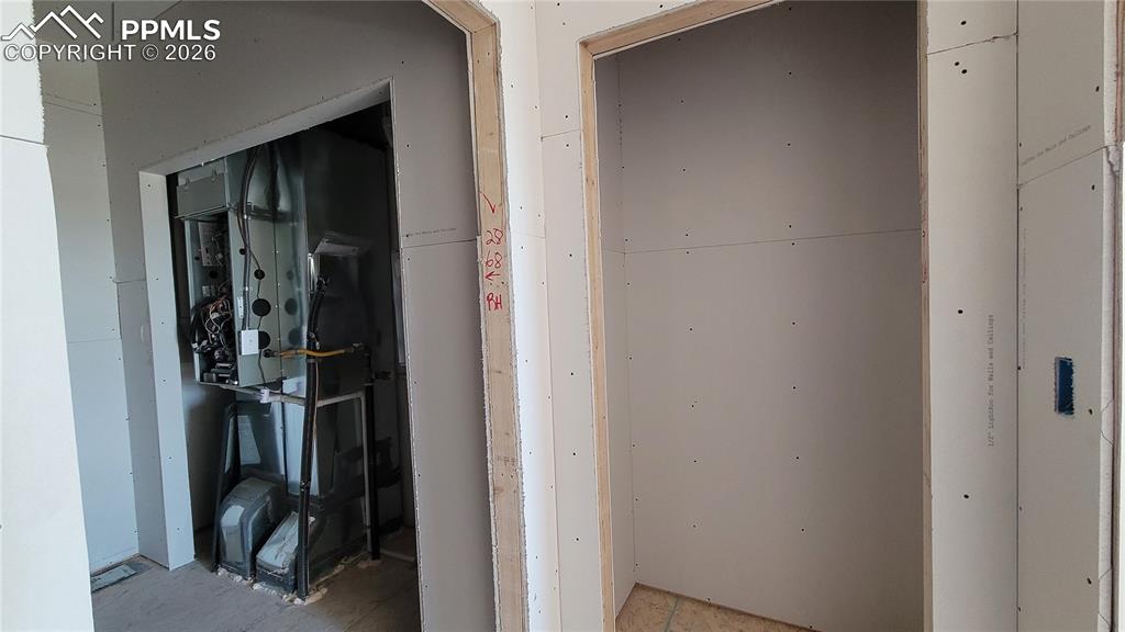 Image 18 of 33: Coat Closet, located off the laundry room/garage!  Please, excuse our dust 