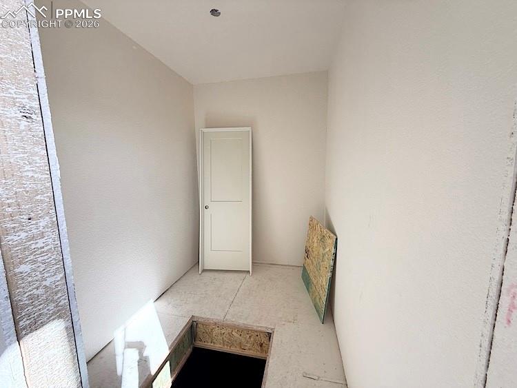 Image 21 of 33: Primary Closet with wood shelving and rods!  Please, excuse our dust as thi