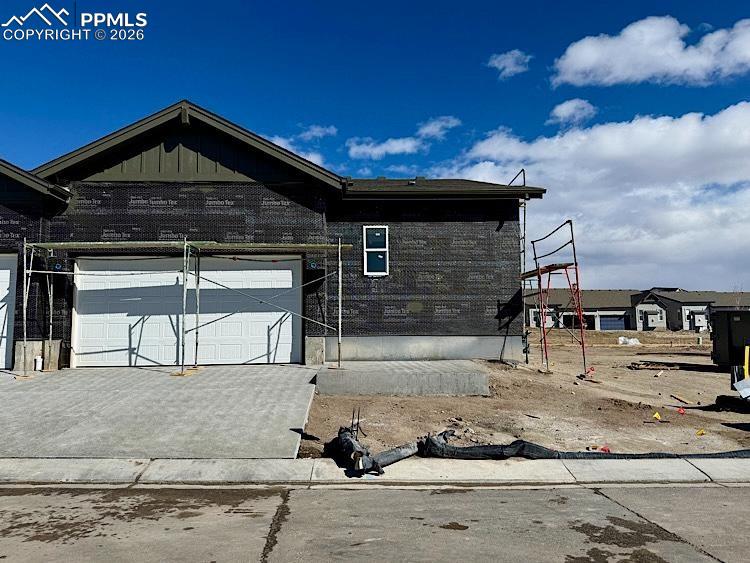 Image 31 of 33: 2 Car Alley Load Garage with driveway! A patio to enjoy grilling or sitting