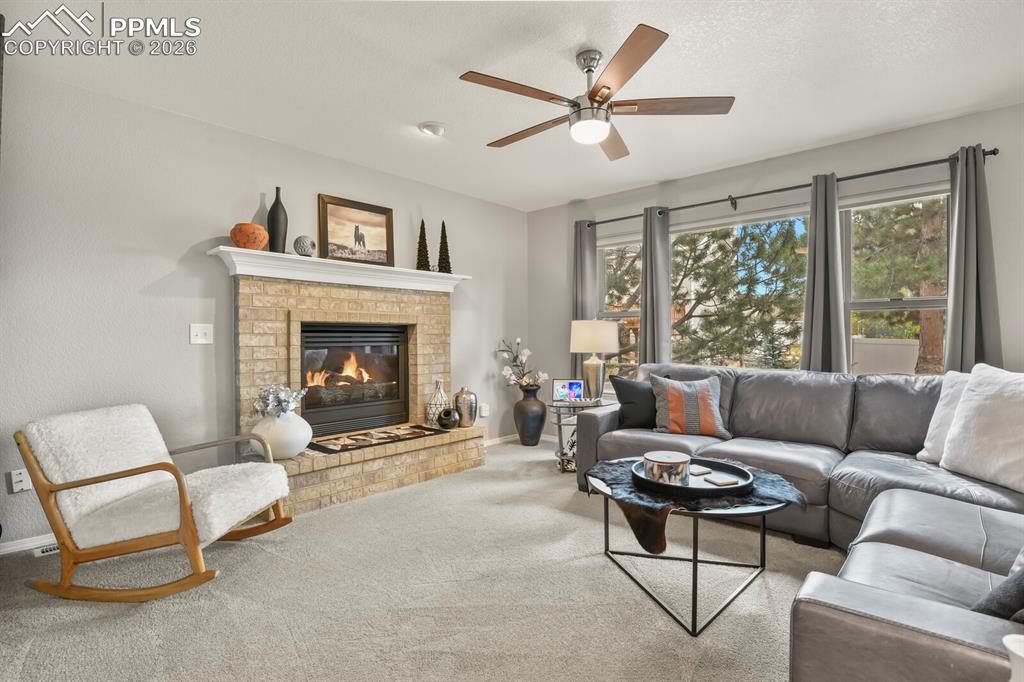 Image 13 of 36: Family with stunning gas fireplace perfect for those chilly Colorado nights