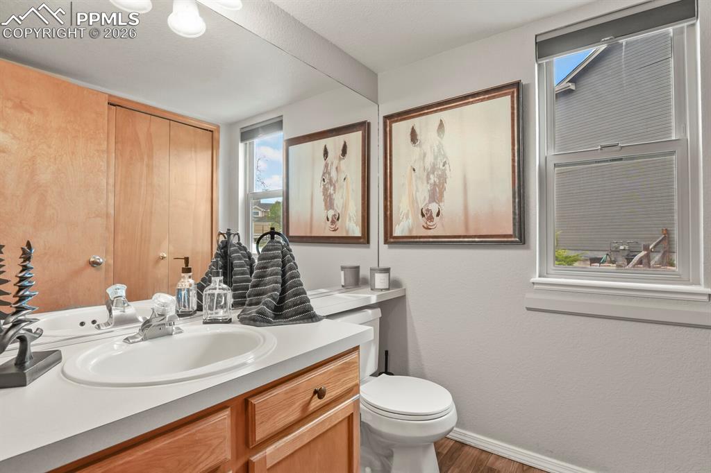 Image 17 of 36: Bathroom with washer and dryer on the level with the family room.