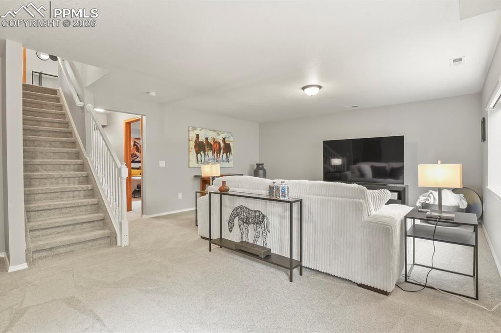 Image 27 of 36: Large family room in the basement.