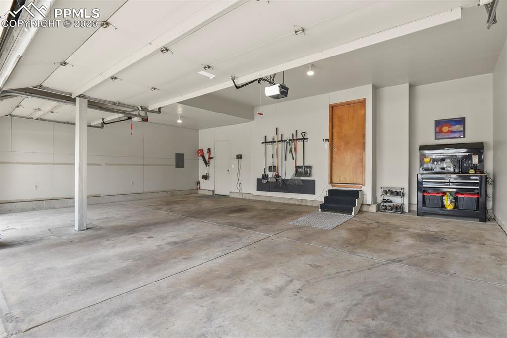 Image 31 of 36: Immaculate oversized 3 car garage. The perfect plea for your cars or tolls