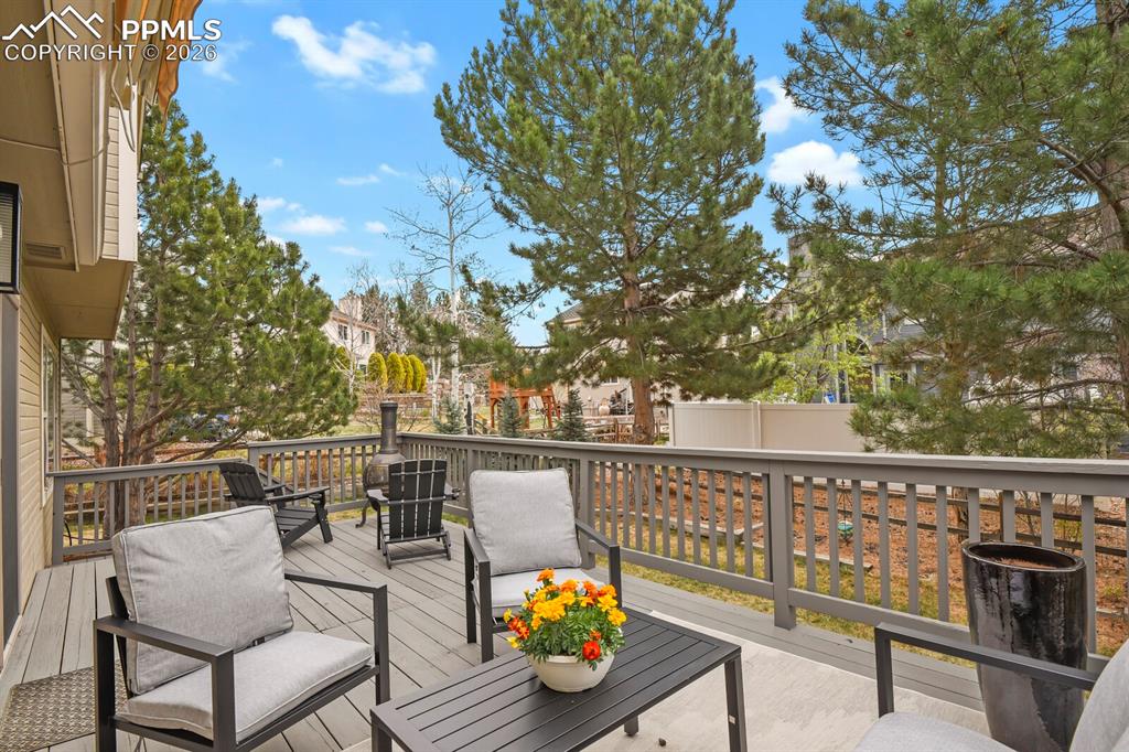 Image 32 of 36: Back deck with beautiful landscaping