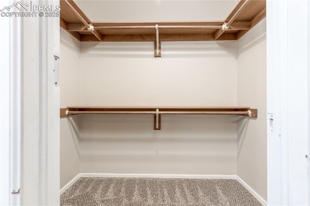 Image 19 of 38: Walk-in closet in primary bedroom