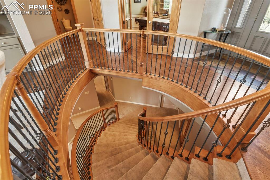 Image 21 of 39: Stairway with carpet floors and baseboards