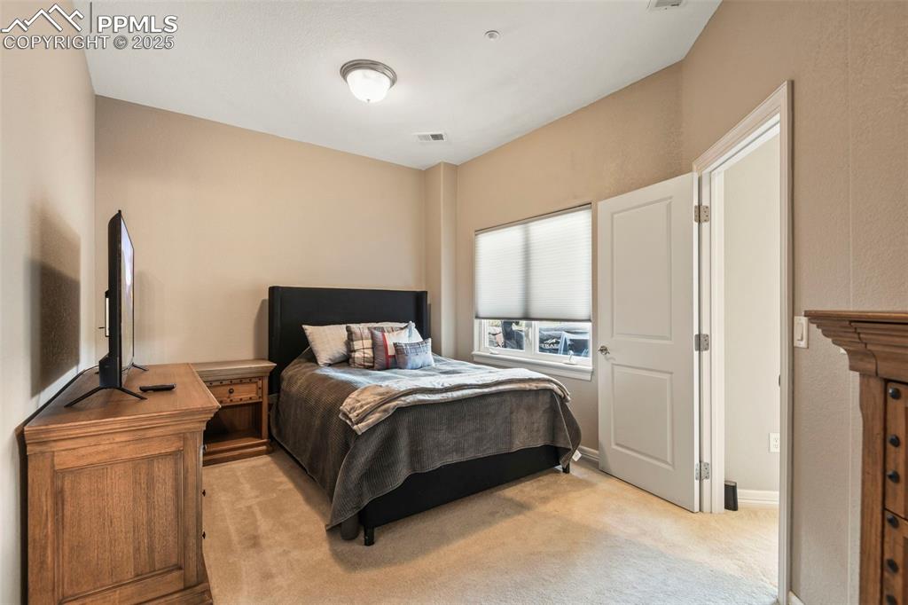 Image 24 of 39: Bedroom with light carpet and baseboards