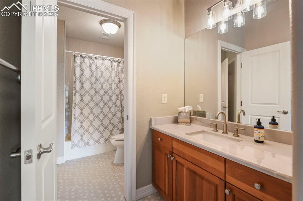 Image 28 of 39: Full bathroom with vanity and shower / bath combination with curtain