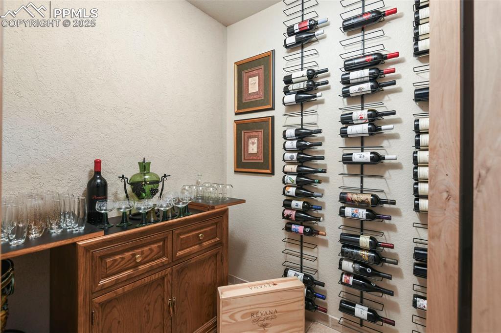 Image 30 of 39: Wine area with a textured wall