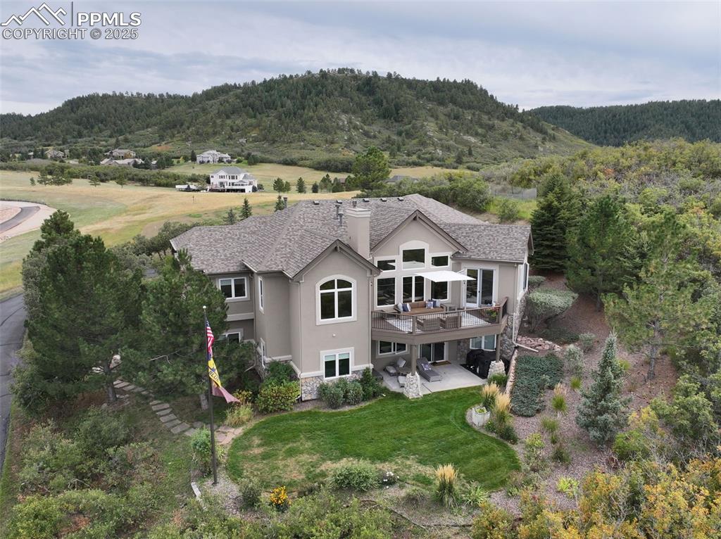 Image 37 of 39: Aerial view of property and surrounding area with a heavily wooded area