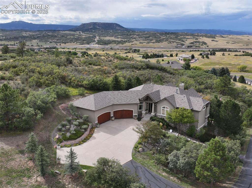 Image 39 of 39: View of subject property with mountains and a tree filled landscape