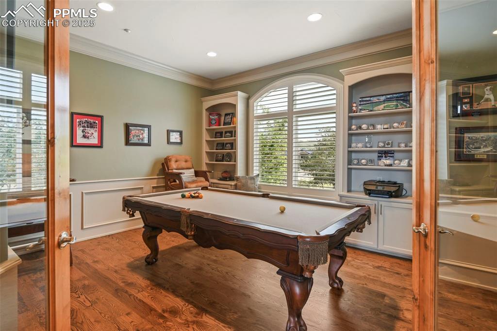 Image 7 of 39: Recreation room with crown molding, billiards, wood finished floors, recess