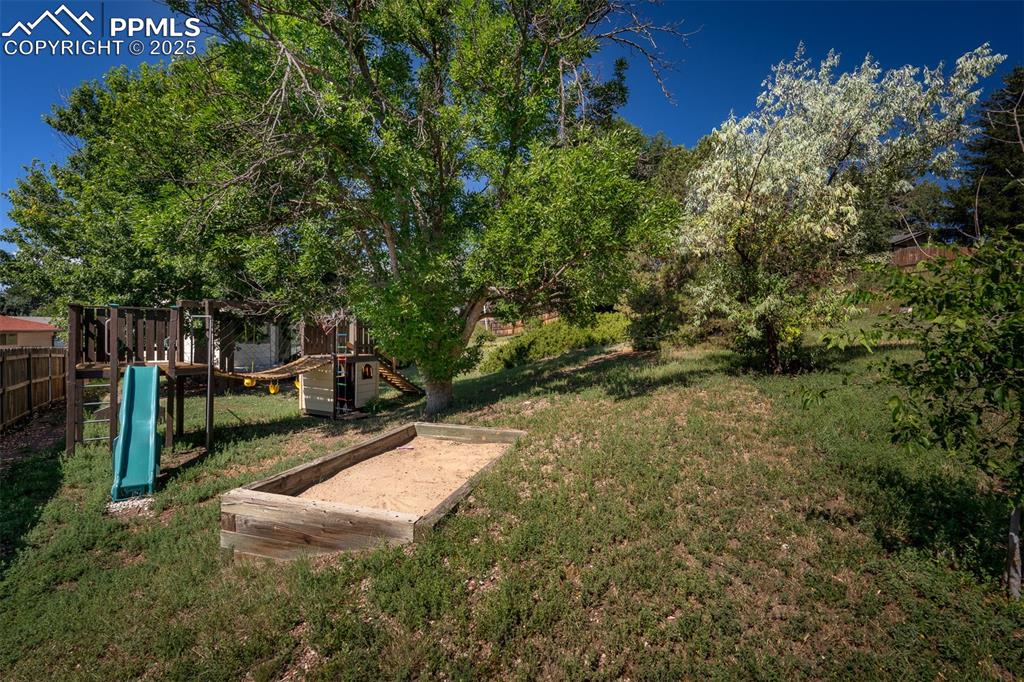 Image 11 of 49: Huge back yard featuring the playground.