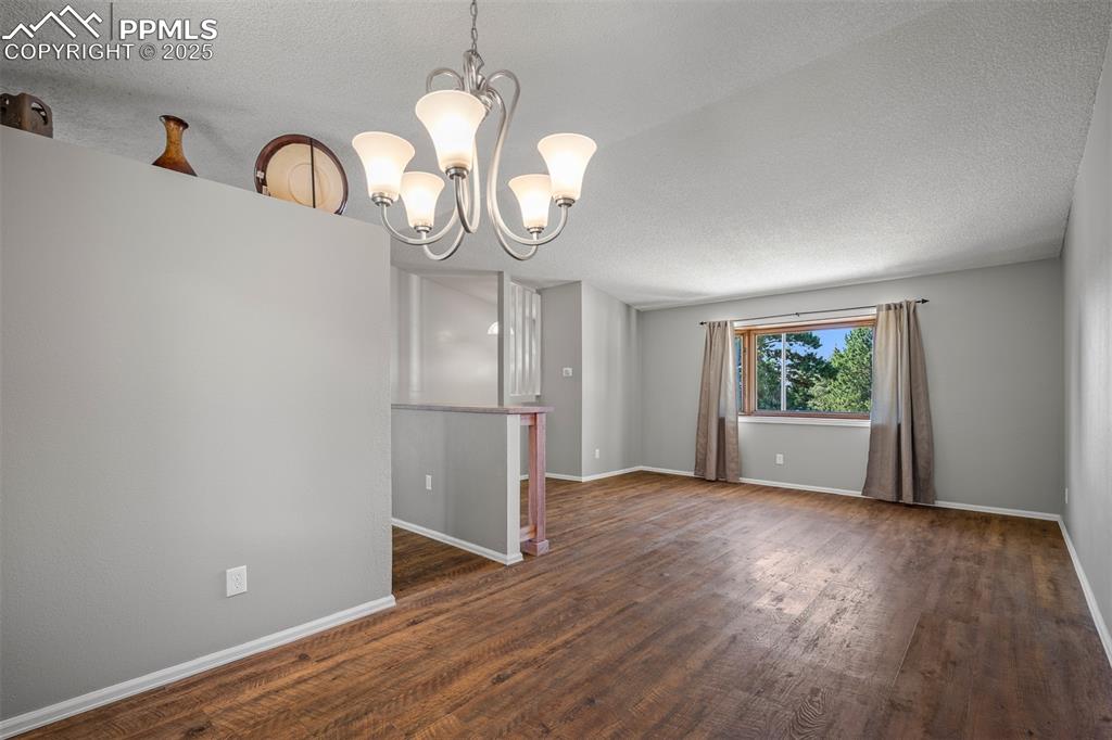 Image 23 of 49: View of spacious living room from dinning area perspective.
