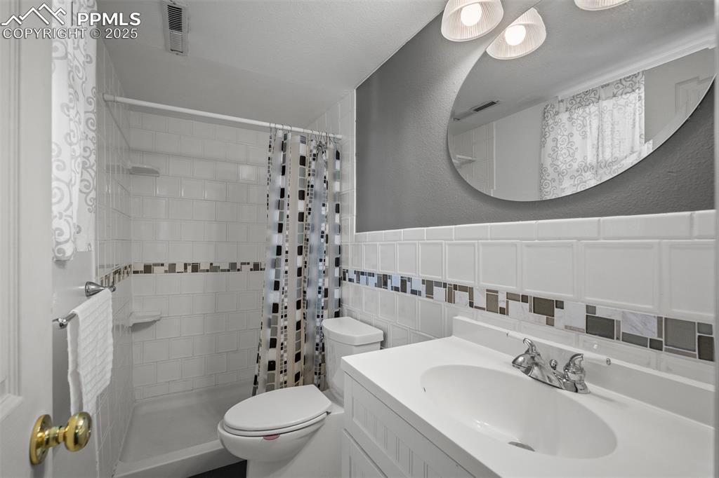 Image 36 of 49: Private bathroom for lower level bedroom.