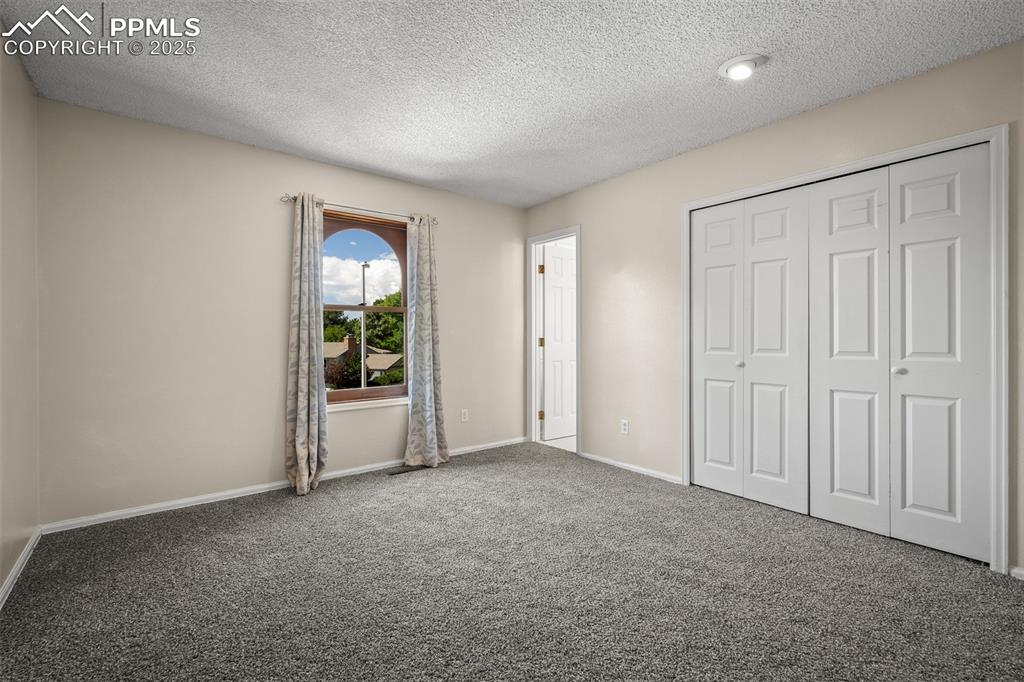 Image 38 of 49: Primary bedroom with private bathroom and new carpet.