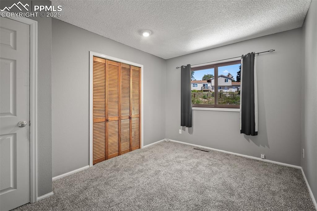 Image 41 of 49: Second upstairs bedroom with new carpet.