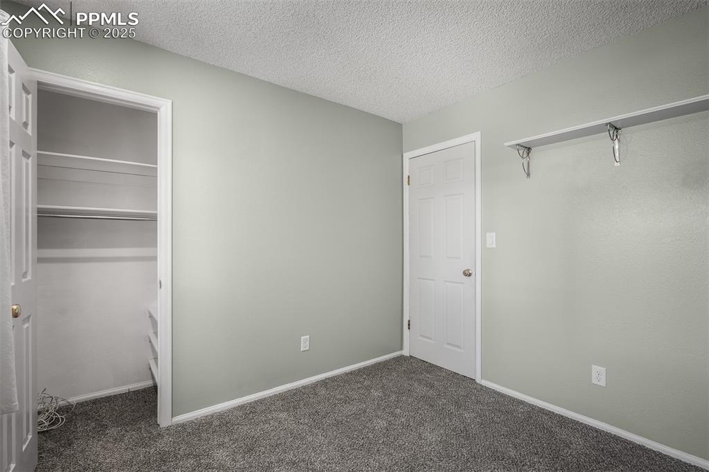 Image 45 of 49: Basement bedroom with new carpet.