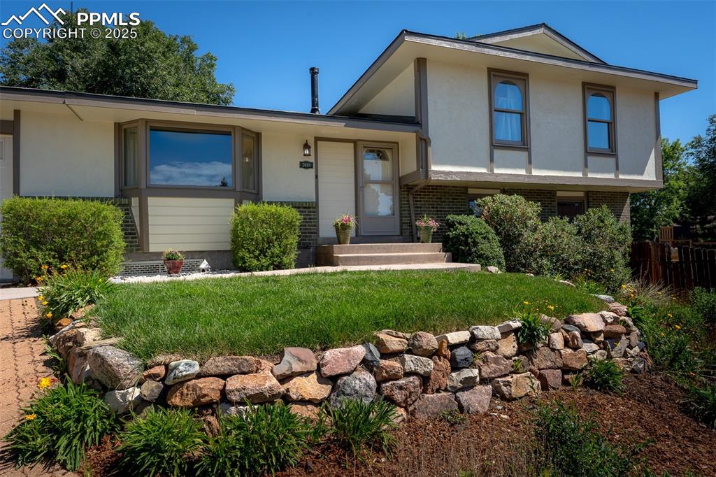 Image 48 of 49: View of front of house with brick siding and stucco siding