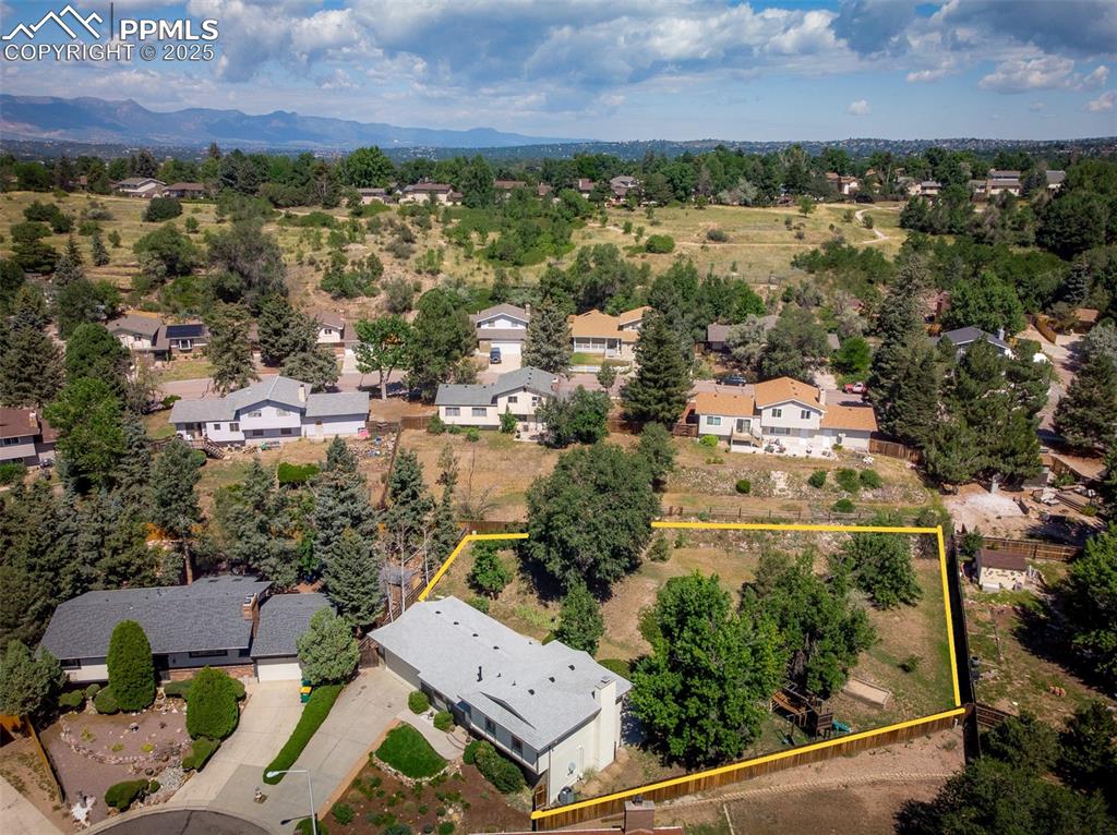 Image 5 of 49: Aerial perspective of back yard area featuring property parcel outlined and