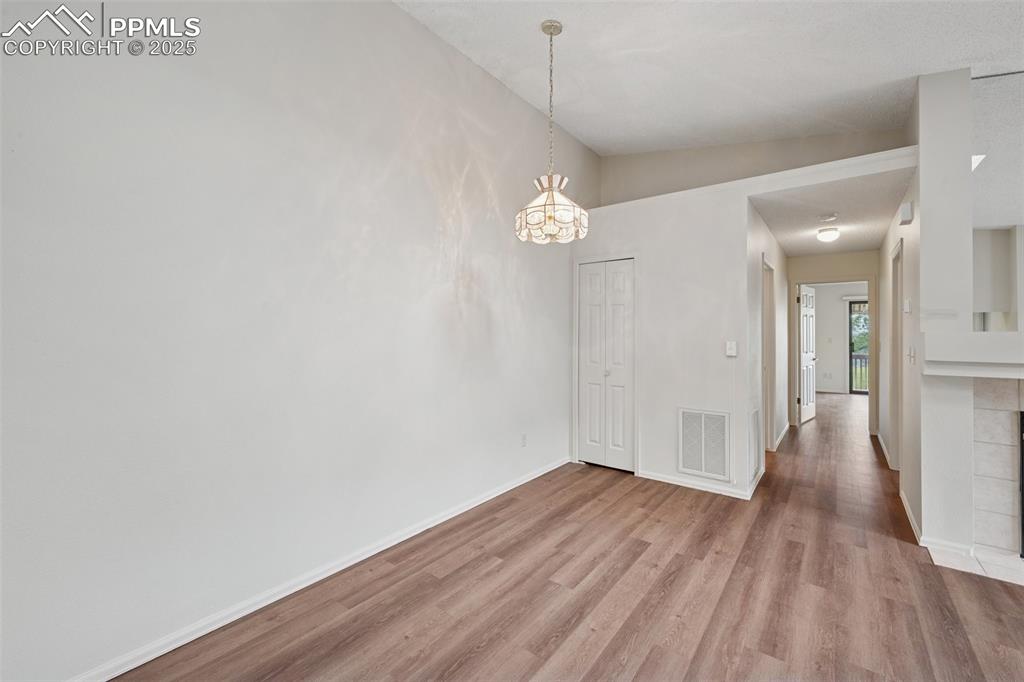 Image 11 of 27: The dining area features a vaulted ceiling and a closet