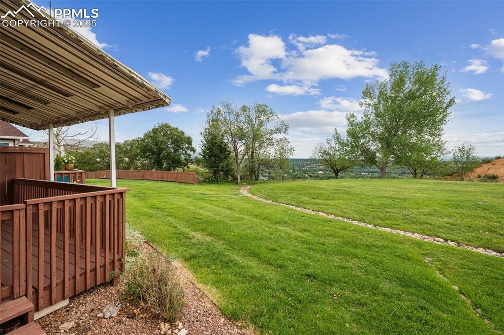 Image 19 of 27: The property backs to open space with sweeping city views and access to a w