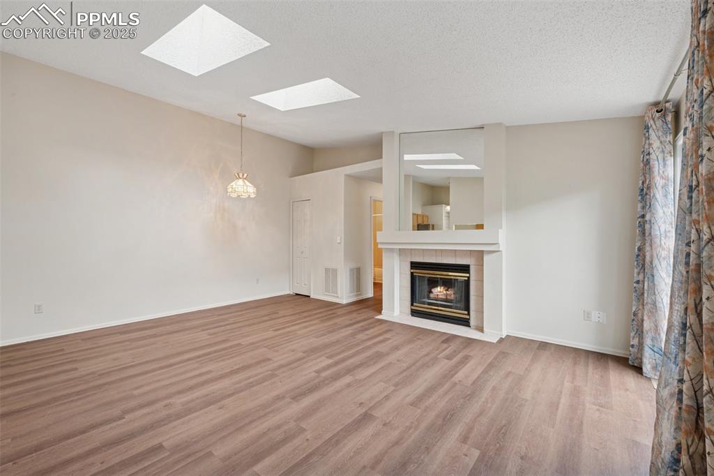 Image 5 of 27: Enjoy spending time in the living room bathed in natural light from two sky