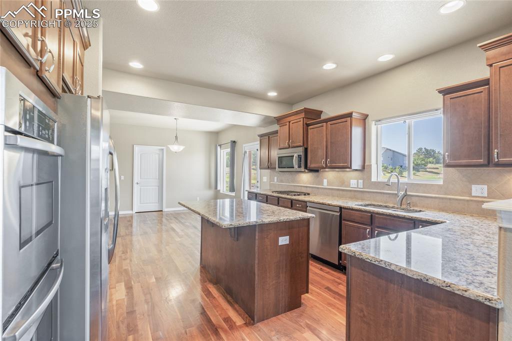 Image 14 of 34: The kitchen is gorgeous with plenty of storage space, hardwood floors, and
