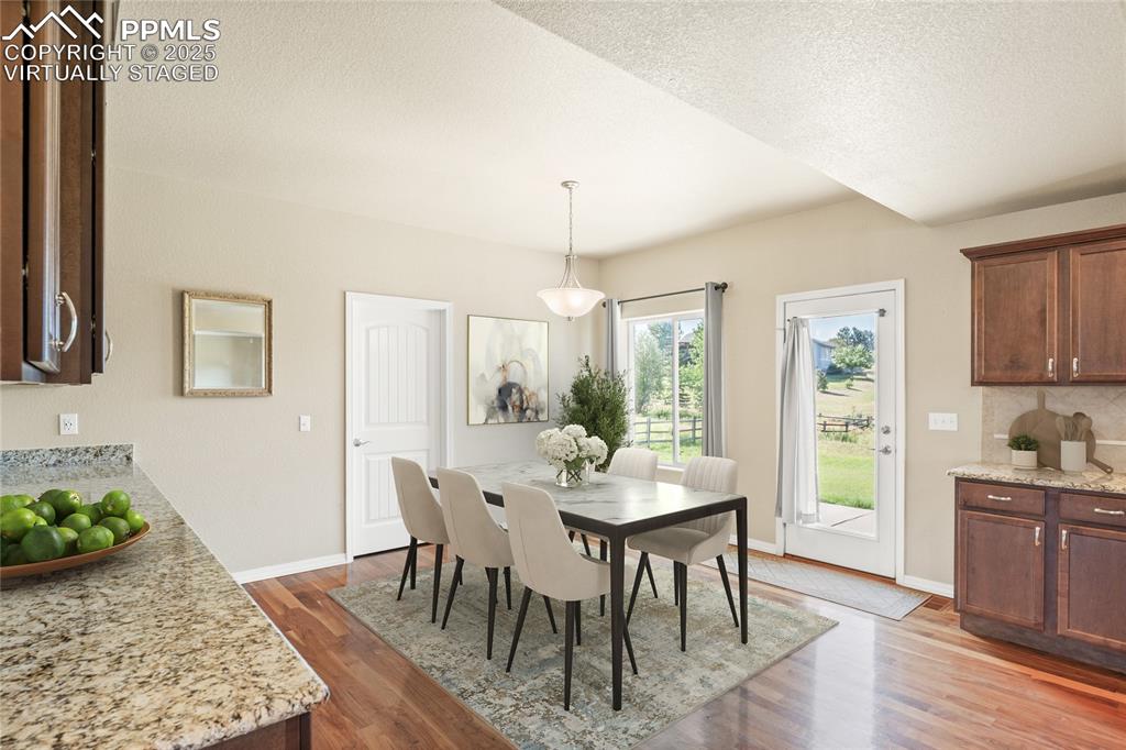Image 16 of 34: Virtually Staged: There is space in the kitchen for a large dining table.