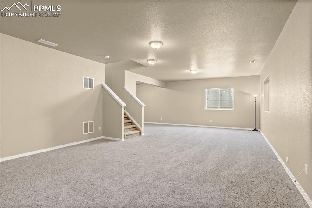 Image 20 of 34: There is a huge basement! It could be used for a media room, game tables,