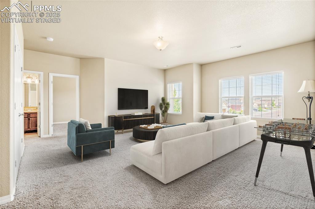 Image 25 of 34: Virtually Staged: The upper level has a HUGE loft. This space could be use