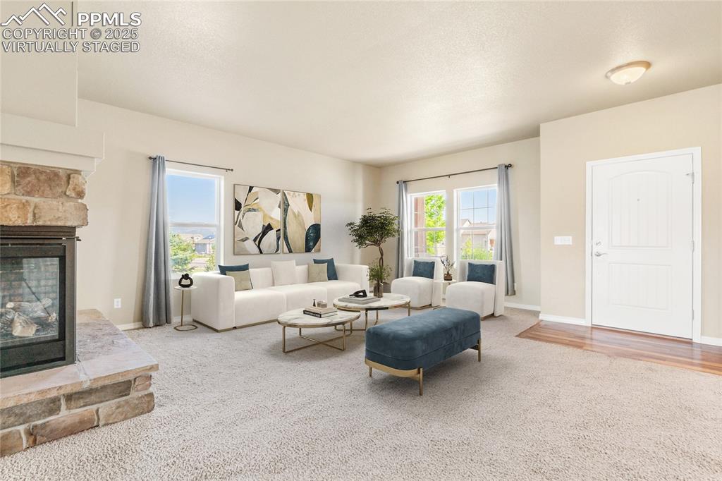 Image 4 of 34: Virtually Staged: Enter to a formal living room with 3 sided fireplace.