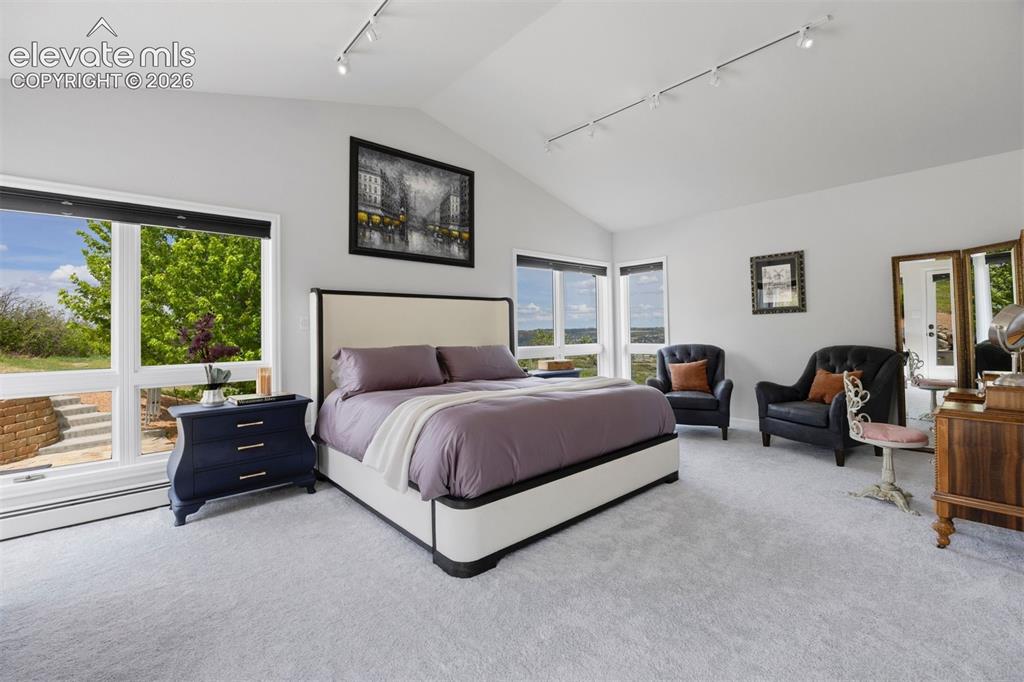 Image 13 of 38: Expansive living room with vaulted ceiling, three skylights, and panoramic