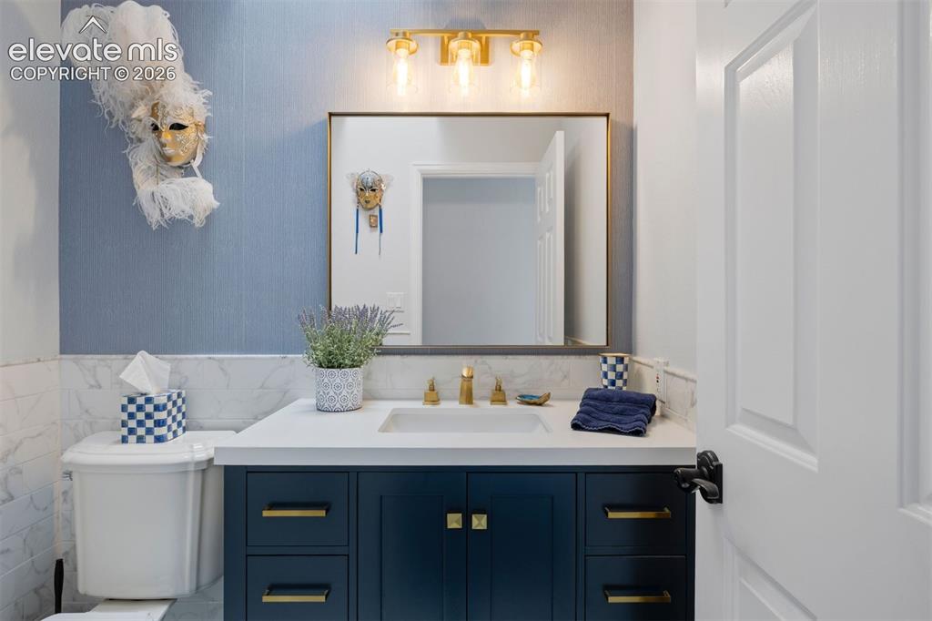 Image 17 of 38: Primary bath with dual vessel sinks, dramatic black cabinetry, quartz count