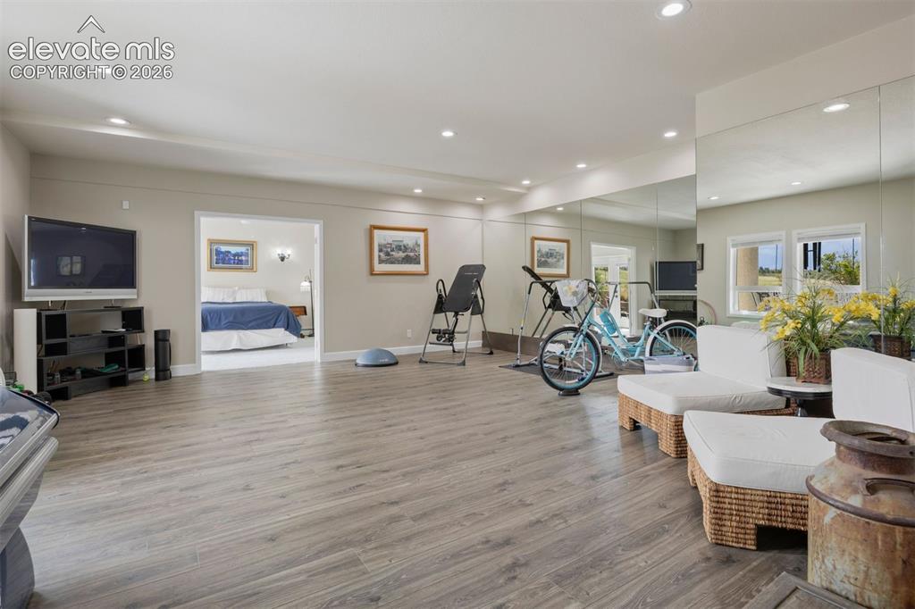 Image 21 of 38: A large recreation room easily houses a billiards table, sitting areas, and