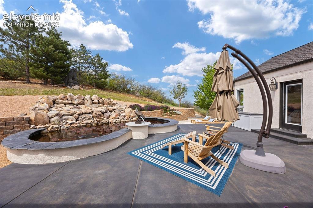 Image 25 of 38: Guest suite with double-door entry, private patio access, and large walk-in