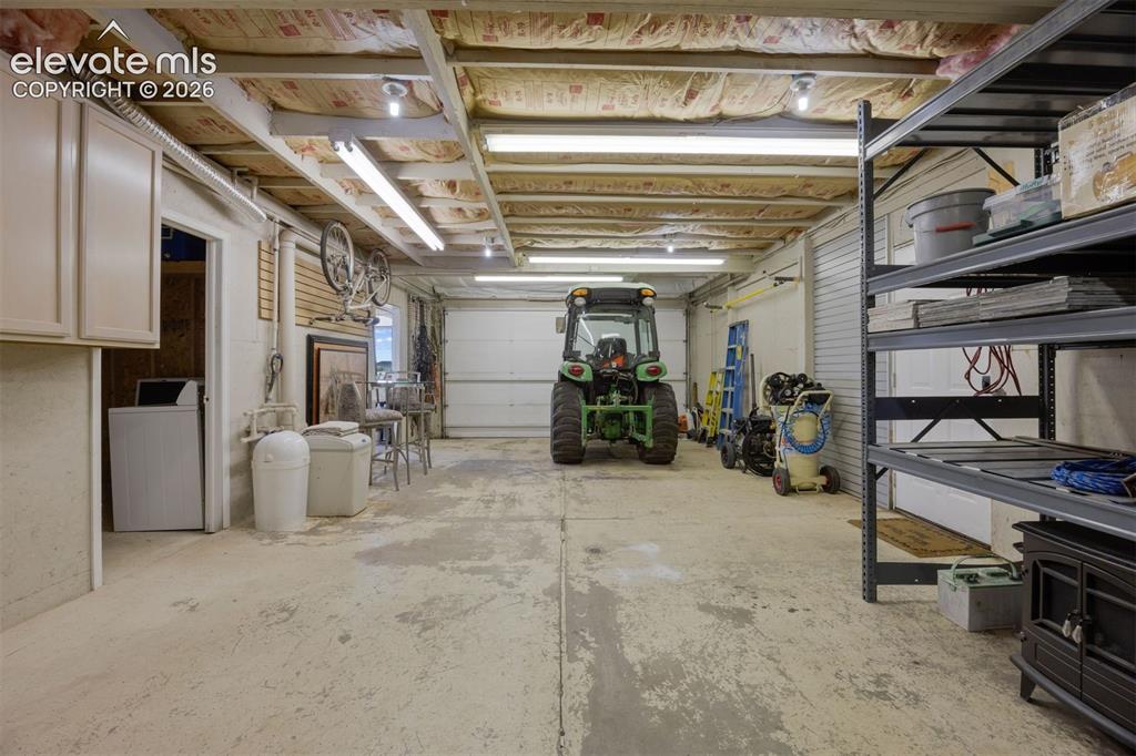 Image 31 of 38: Covered deck located off the kitchen and living areas, with stone columns,