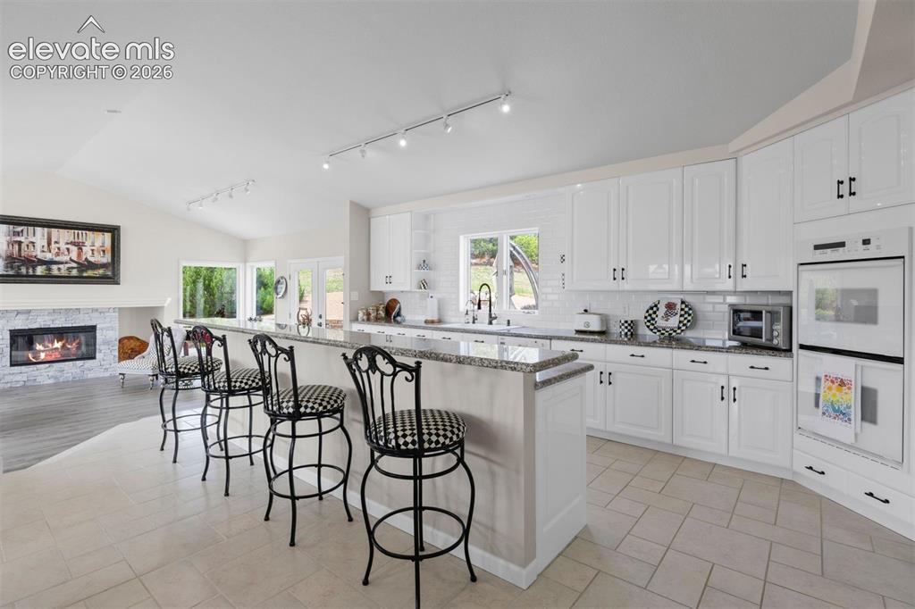 Image 5 of 38: The raised ranch layout places all principal living areas - kitchen, dining
