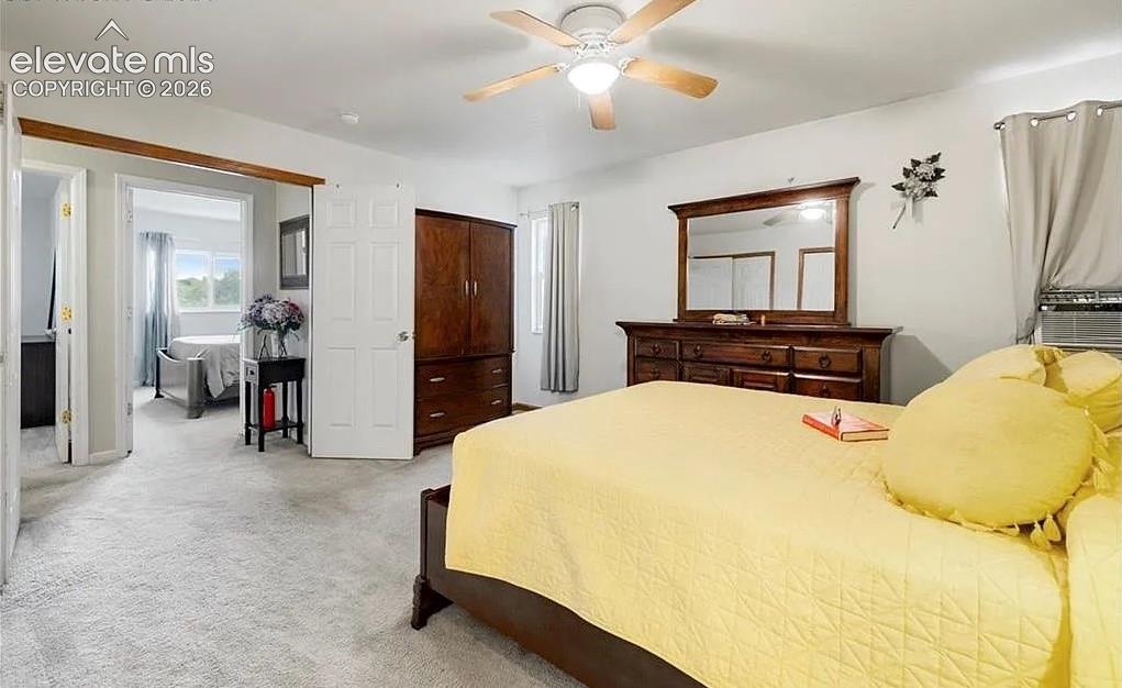 Image 11 of 20: Spacious room with light gray carpeting and white walls