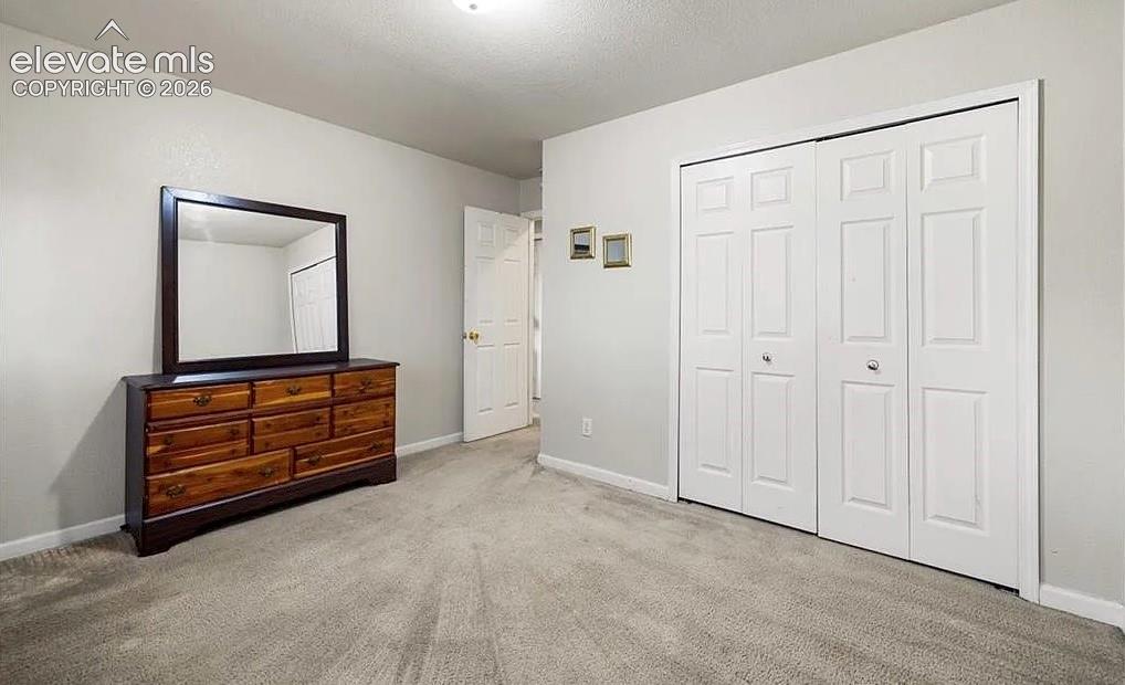 Image 14 of 20: Neutral tone walls with carpeting throughout