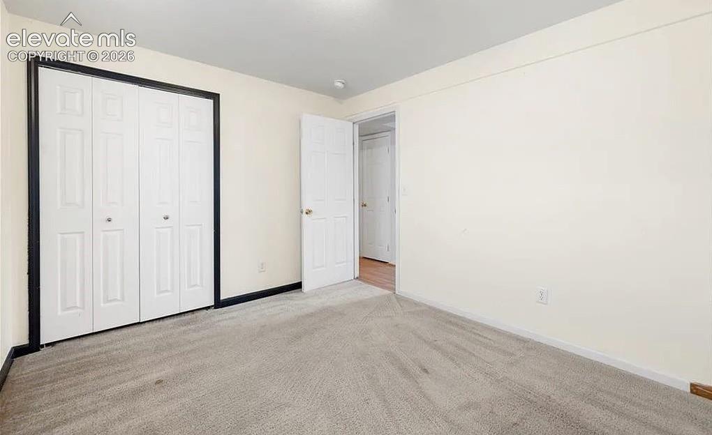 Image 17 of 20: Interior room featuring neutral wall paint and light-colored carpet