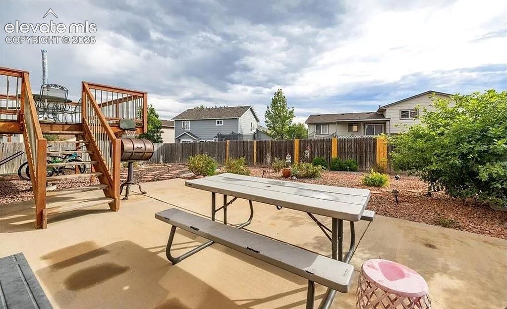 Image 19 of 20: Expansive outdoor patio area featuring a multi-level wood deck and stairs,