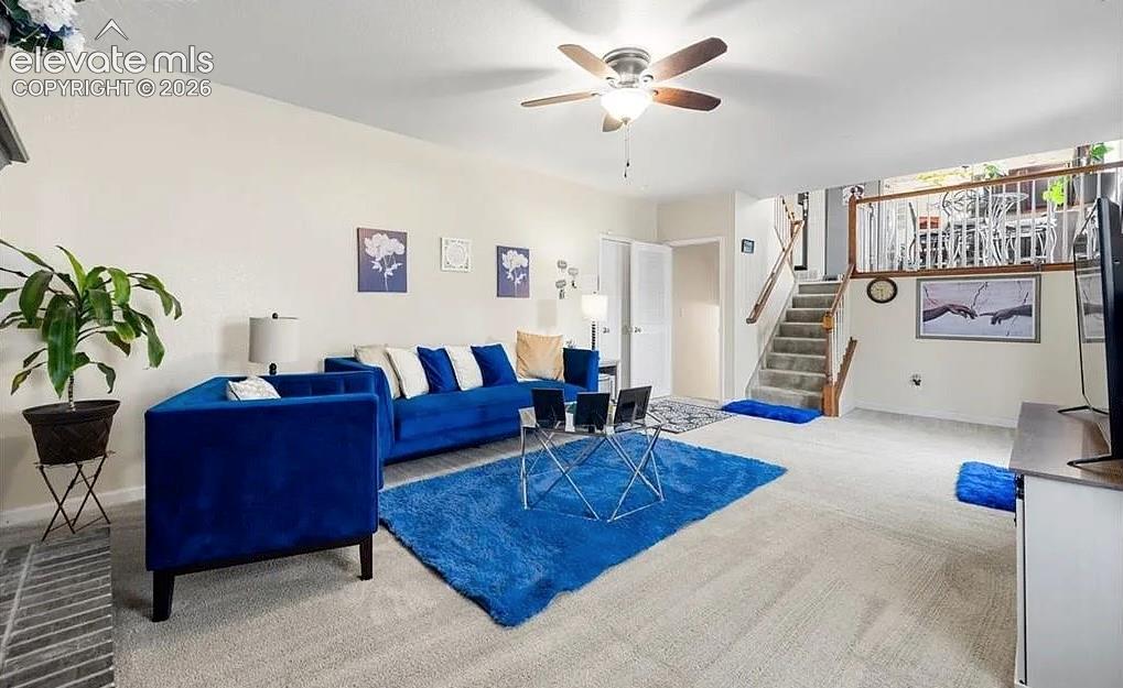 Image 9 of 20: Spacious living area featuring light-colored walls and carpet flooring