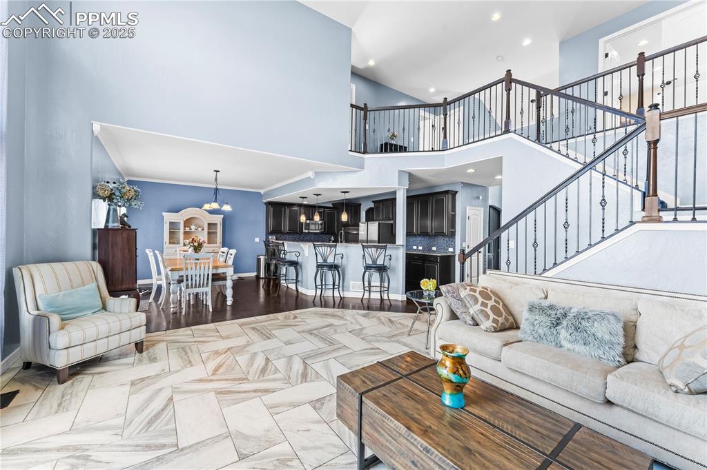 Image 15 of 48: Main Level Living room featuring a high ceiling, recessed lighting, wood fi