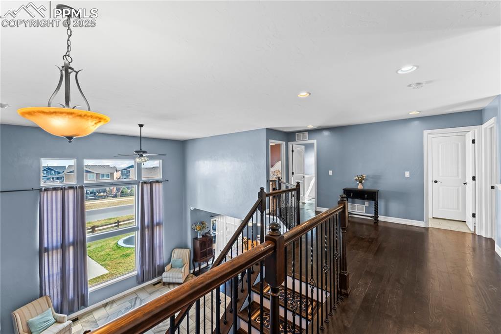 Image 25 of 48: Upstairs Hall with an upstairs landing, dark wood finished floors, and rece